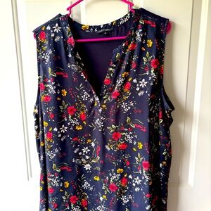Sleeveless tunic blouse in navy with floral print front.